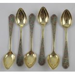 A set of six Russian silver gilt teaspoons with beaded and enamelled floral decorated handles,