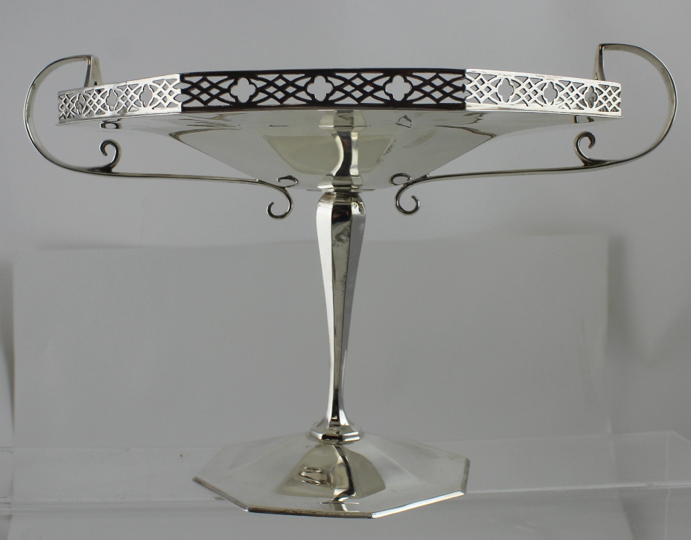 A George V hallmarked silver octagonal twin-handled shallow bowl on tapering column supports to