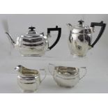 A George VI hallmarked silver four-piece tea set comprising teapot, length 27cm, hot water pot,