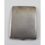 A George V hallmarked silver engine-turned cigarette case, initialled in oval cartouche JB,