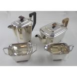 A George VI hallmarked silver four-piece tea service, teapot, hot water pot,