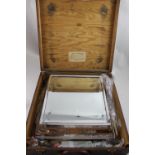 A square section mirrored electroplated cake stand with bright-cut foliate scroll detail and vacant