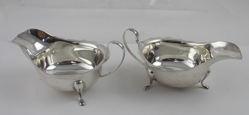 A pair of George V hallmarked silver sauce boats with shaped rims, Emile Viner Ltd, Sheffield 1933,