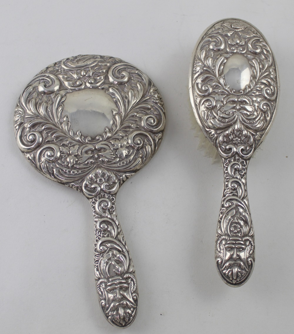 An Elizabeth II hallmarked silver two-piece vanity set, hand mirror and hair brush, Broadway & Co,