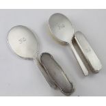 A George V hallmarked silver five-piece vanity set, a hand mirror,