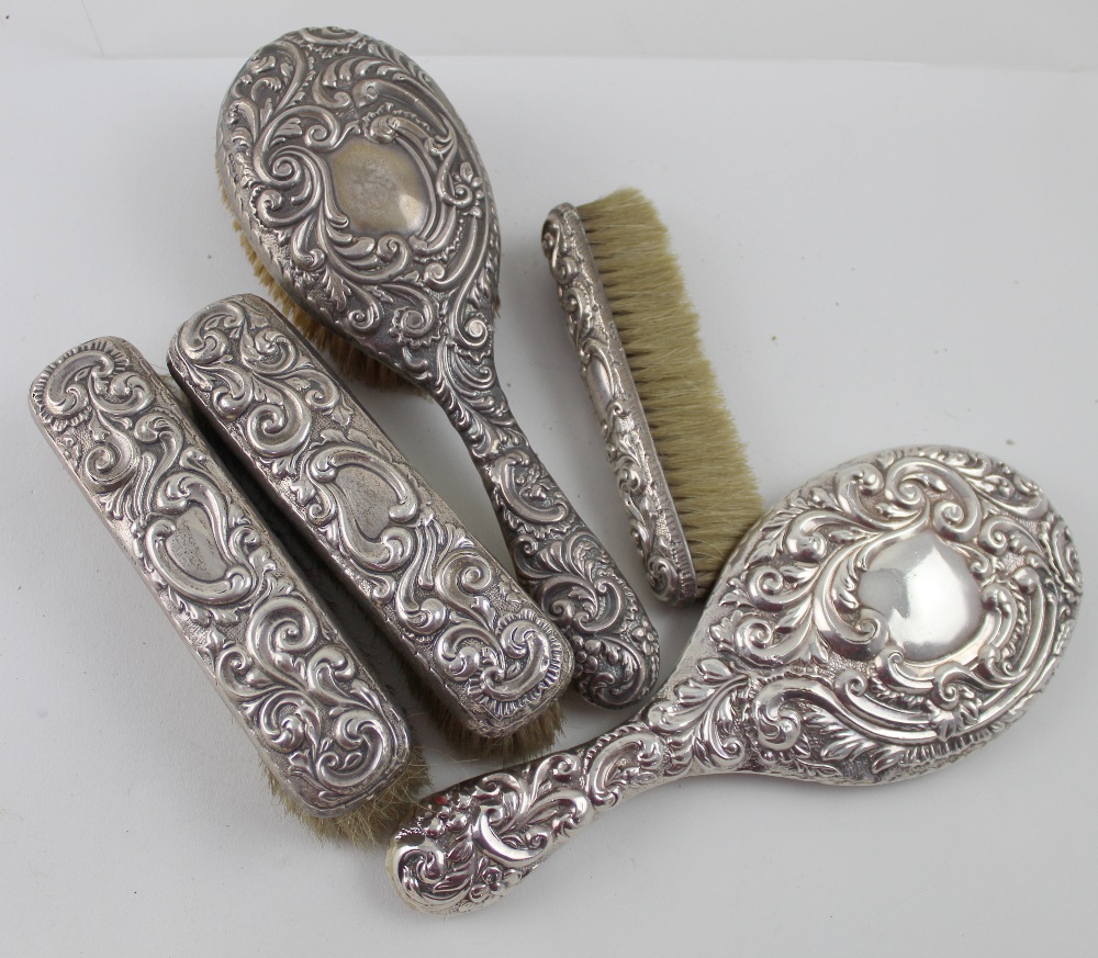 A Victorian hallmarked silver five-piece vanity set, hand mirror,