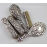 A Victorian hallmarked silver five-piece vanity set, hand mirror,