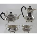 A George V hallmarked silver four-piece tea service, hot water jug, teapot, sucrier and milk jug,