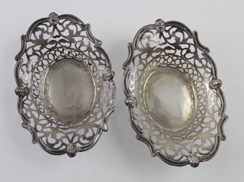 An Edward VII hallmarked silver oval bonbon dish with pierced decoration inside a cast rim,