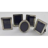 Four Elizabeth II hallmarked silver mounted rectangular photograph frames with beaded detail,