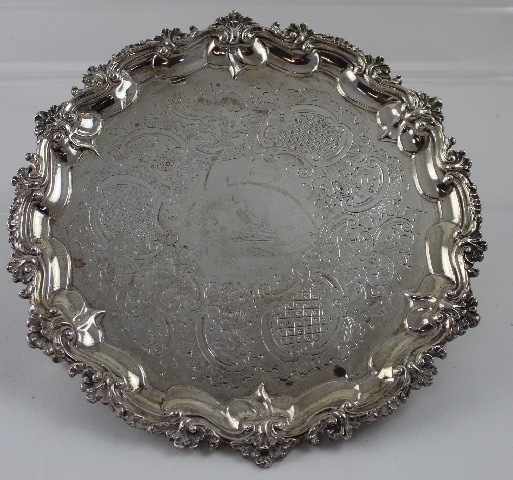 A George III hallmarked silver salver with chased work and decorative shell border to four small