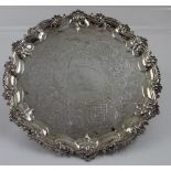 A George III hallmarked silver salver with chased work and decorative shell border to four small