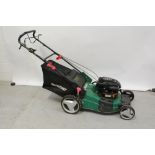 A Qualcast Briggs & Stratton 500 Series 158cc petrol lawnmower and a wooden slat garden bench on