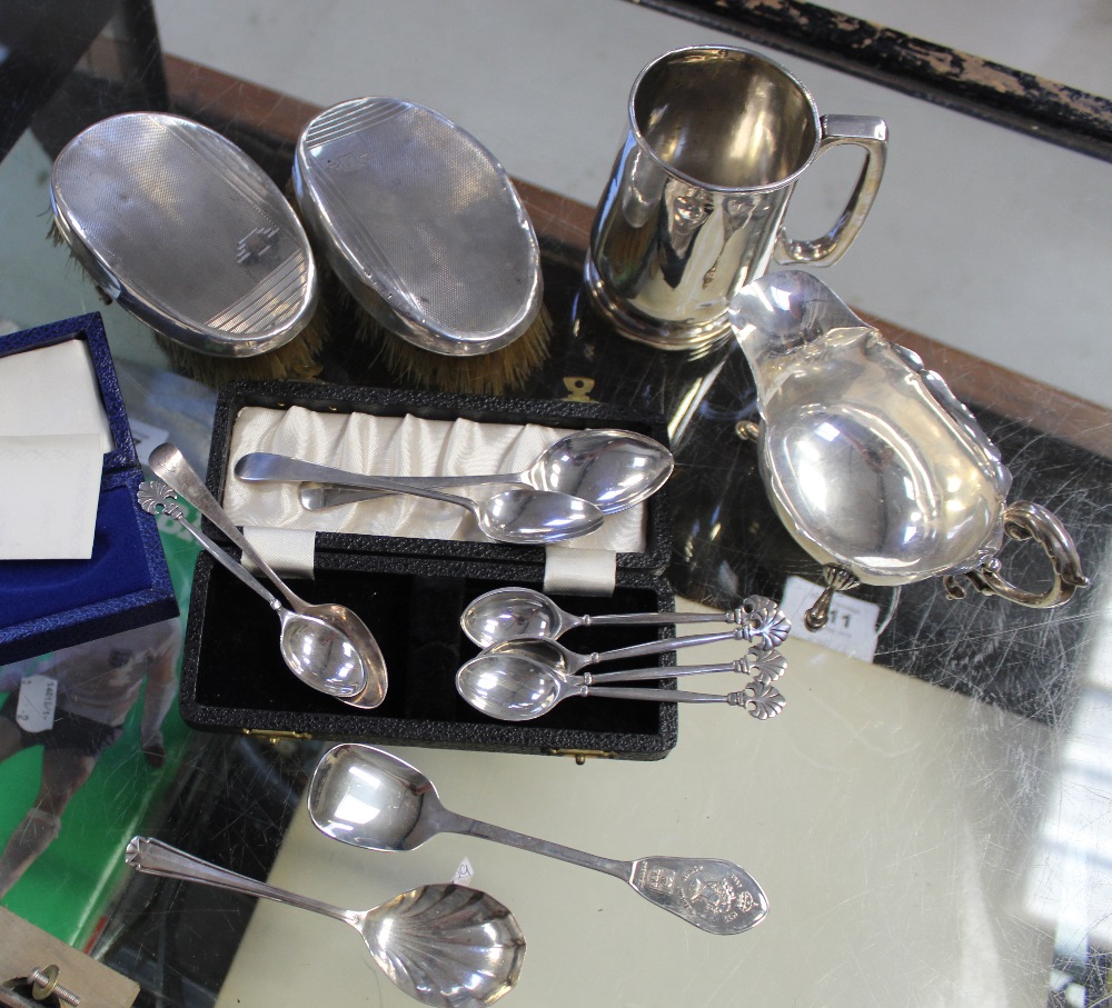 A mixed group of variously hallmarked silver items including sauce boat, mug (af),