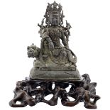 Guanyin auf FabeltierChina Ming 16./17. Jh. Bronze mit dunkler Patina und Resten einer