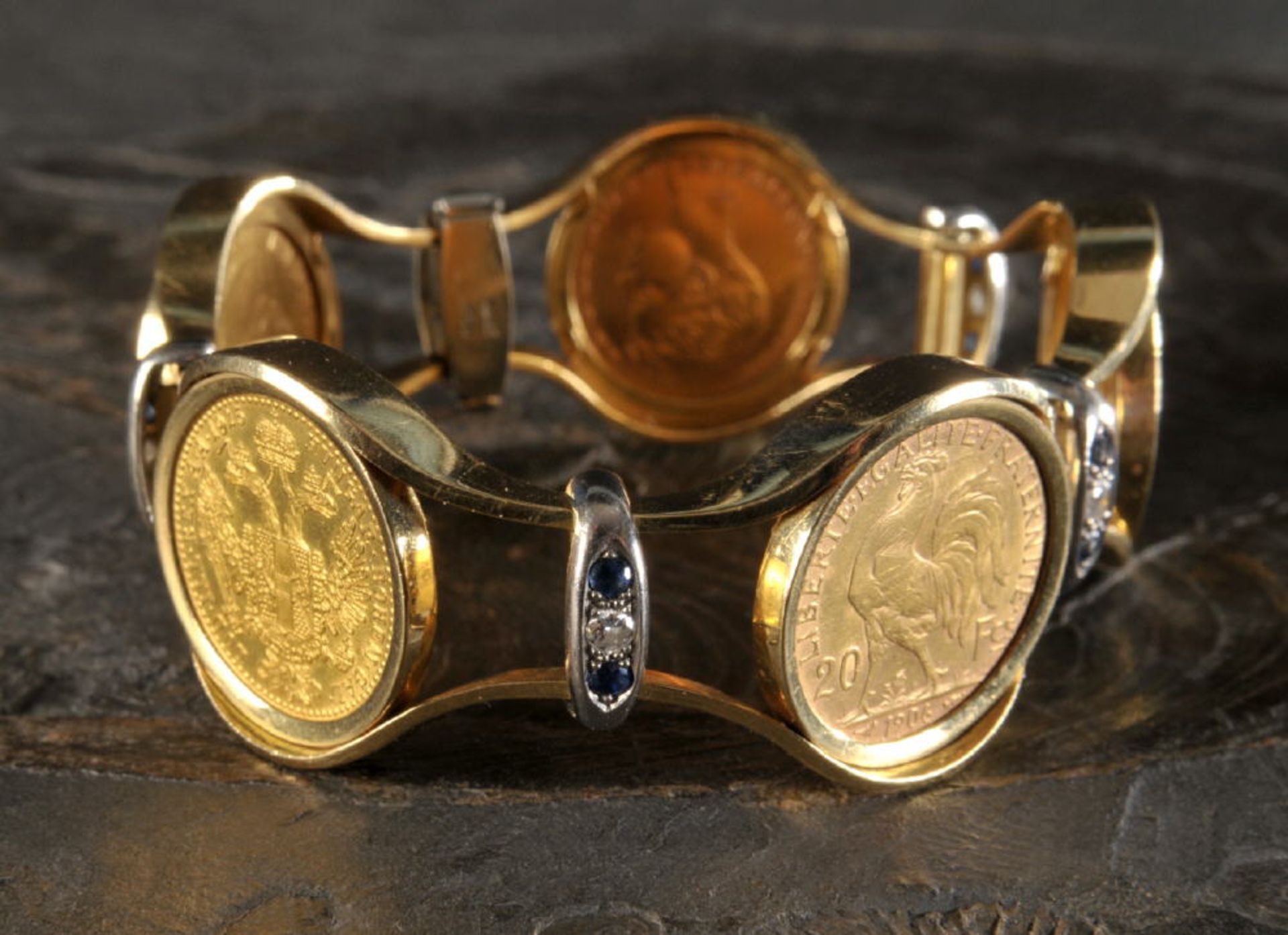 Armband750 GG/WG, ca. 80 g, Dekor mit 5 europäischen Goldmünzen, 4 Brillanten, 8 Saphire, L= 18 cm