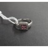 9ct white gold ring set with 4 pink sapphire and a brilliant cut diamond