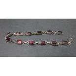 Vintage silver bracelet set with emerald cut garnets. 9g