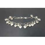 Modernist silver bracelet with heart appendages and claw fastener. Stamped 925. 12 grams