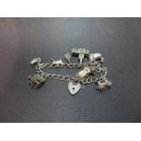 Vintage silver charm bracelet with nine charms. London 1971. 38g