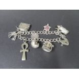 Vintage silver charm bracelet with 8 charms, fully hallmarked Birmingham 1997. Weight 52g