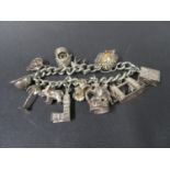 Vintage silver bracelet with13 charms, fully hallmarked Birmingham 1976. Weight 82g.