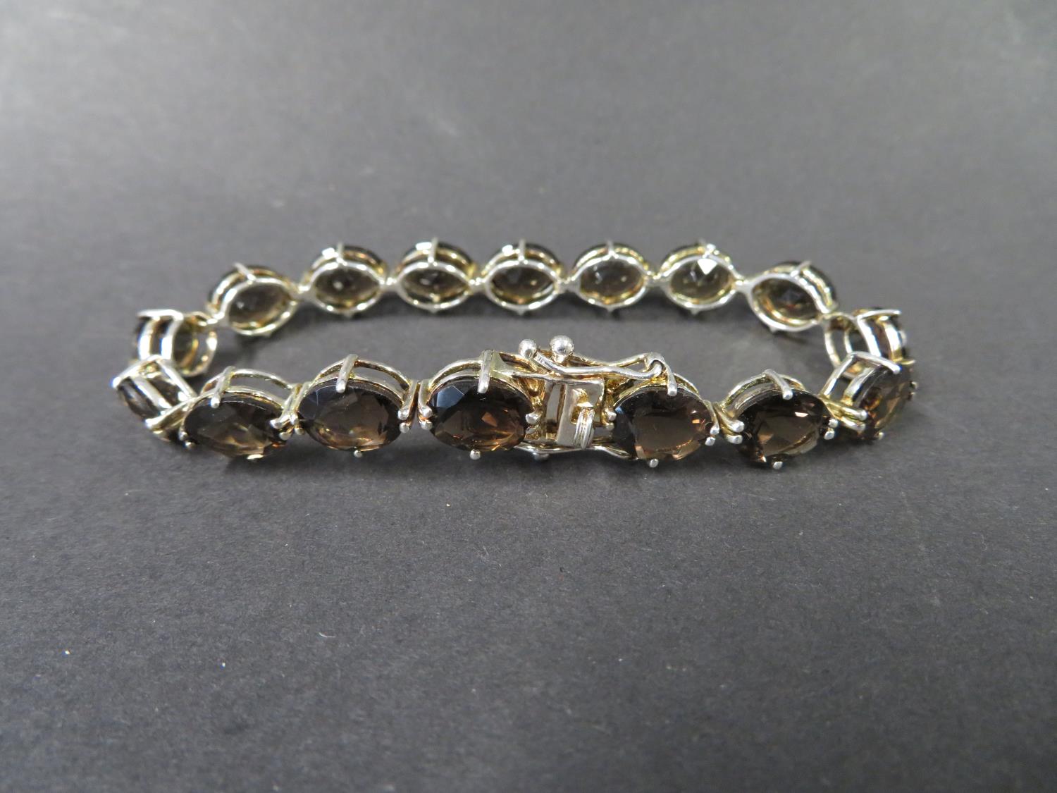 Large size silver bracelet set with smokey quartz stones. Weight 19g