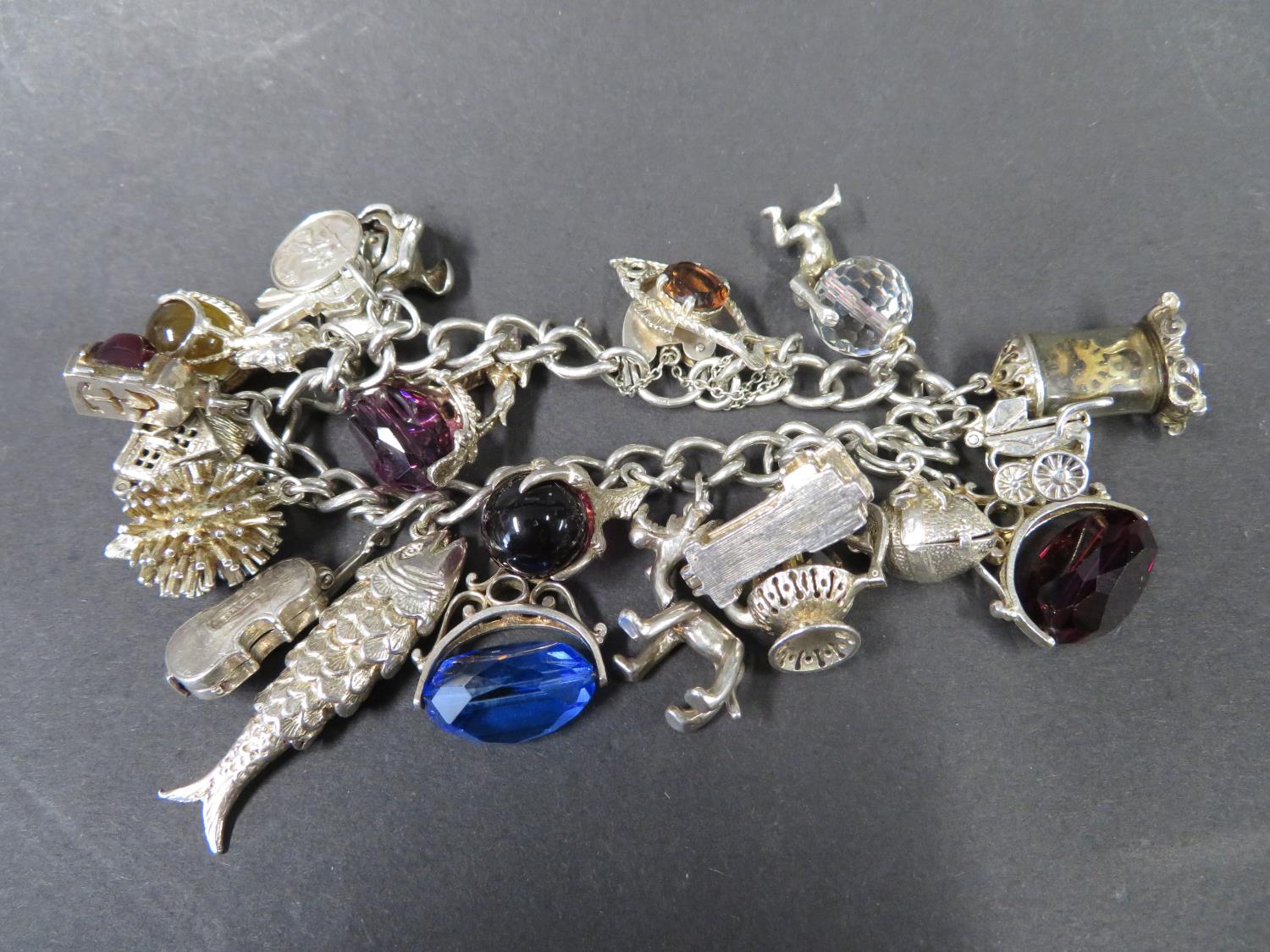 Vintage silver charm bracelet, fully hallmarked Birmingham 1969 with 20 charms. Weight 100g