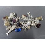 Vintage silver charm bracelet, fully hallmarked Birmingham 1969 with 20 charms. Weight 100g