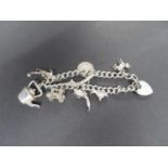 Vintage silver charm bracelet HM Birmingham 1972 8 charms 35 grams