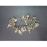 Vintage silver charm bracelet with 15 charms hallmarked London 70 grams