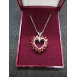 Pretty heart shaped reversible silver pendant and chain with red stones one side and white stones on