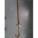 Carved shepherd's crook, one resin walking stick and brass golf club