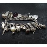 Fine quality vintage silver charm bracelet with 18 charms padlock and chain 86 grams