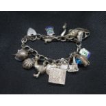 Vintage silver figaro link bracelet with 15 charms including Jemima Puddleduck Birmingham 1972 55