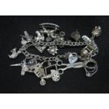 Vintage silver double link charm bracelet with padlock and chain approx 20 charms HM Birmingham 1988