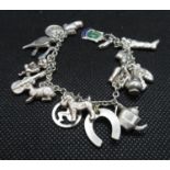 Vintage silver charm bracelet 17 charms weight 26grams