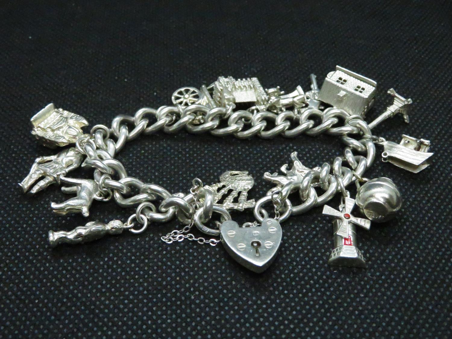 Vintage silver charm bracelet with 15x charms HM London 1955 69grams