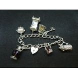 Vintage silver charm bracelet with 7x charms HM London 1973 46.5grams