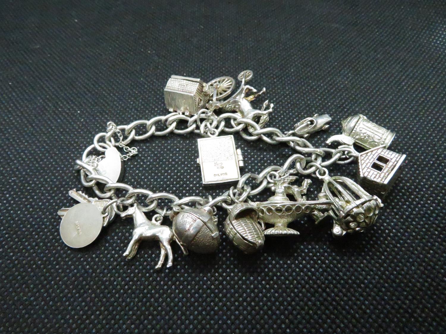 Vintage silver charm bracelet with 14 excellent charms HM Birmingham 1955 58grams