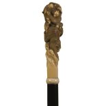 A LATE 19TH/EARLY 20TH CENTURY WALKING CANE, the Japanese Meiji period ivory handle carved as a