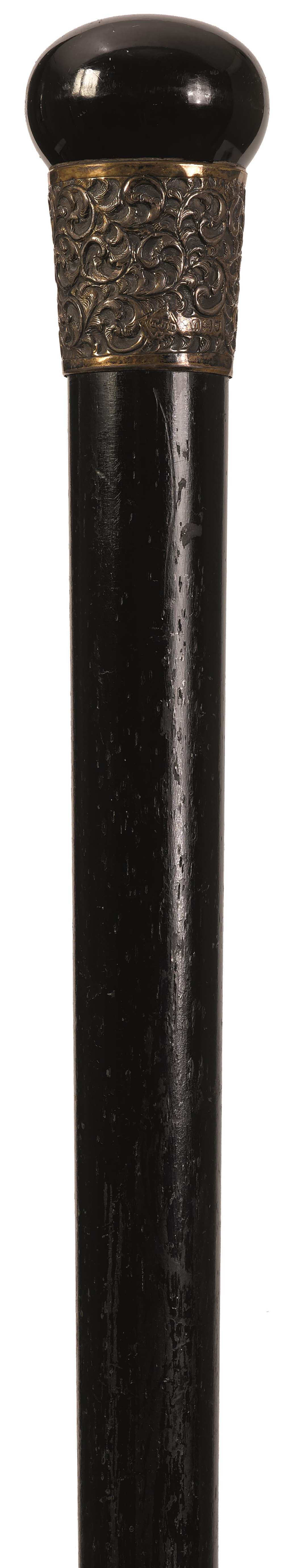 AN EARLY 20TH CENTURY EBONISED WALKING CANE, the bun handle above white metal foliate embossed