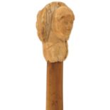 A 19TH CENTURY WALKING CANE, the early ivory handle carved as the head of a Cardinal, bamboo haft,