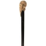 A LATE 19TH/EARLY 20TH CENTURY WALKING CANE, the ivory handle carved as a resting parrot with