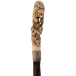 AN EARLY 20TH CENTURY WALKING CANE, the Japanese Meiji period ivory handle carved as a climbing