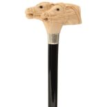 AN EARLY 20TH CENTURY WALKING CANE, the ivory handle carved as two bridled racing horses' heads with