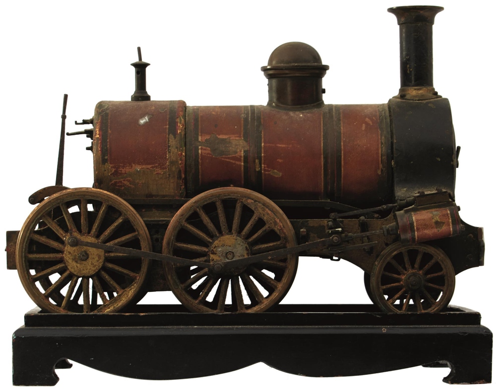 A LIVE STEAM LOCOMOTIVE, lacquered body, 27cm long, on associated ebonised plinth.