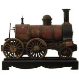 A LIVE STEAM LOCOMOTIVE, lacquered body, 27cm long, on associated ebonised plinth.