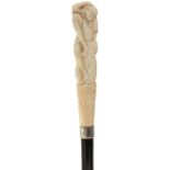 AN EARLY 20TH CENTURY WALKING CANE, the Japanese ivory handle carved as man resting on a rock with