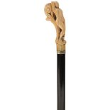 AN ELEGANT WALKING CANE, the early ivory handle carved as a nude female figure reclining against a